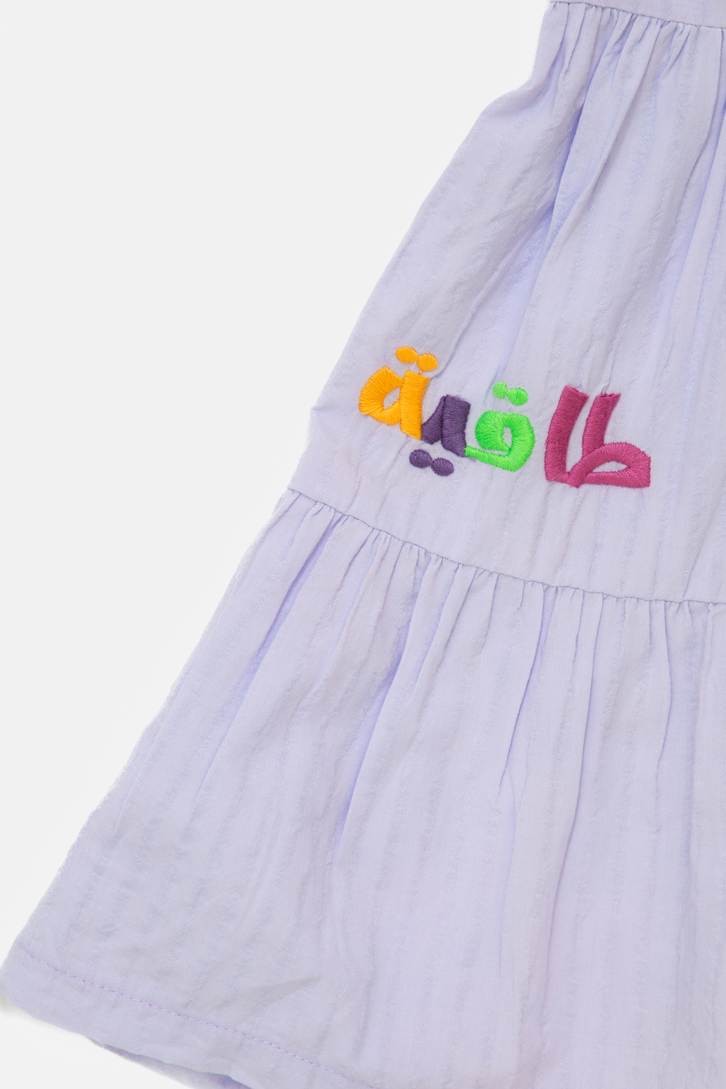 Light purple dress with colorful Arabic embroidery on the fabric from ein-ghein.com